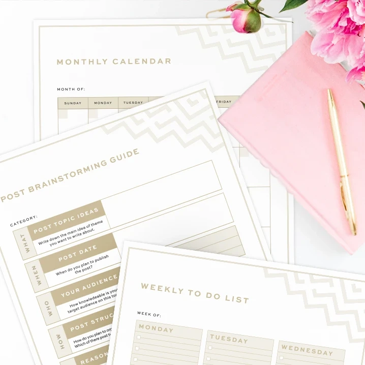 A top-down view of the free 2027 printable planner featuring a post brainstorming guide, a monthly calendar, and a weekly to-do list . The printed pages are styled on a white surface with a pink notebook, a gold pen, and pink flowers