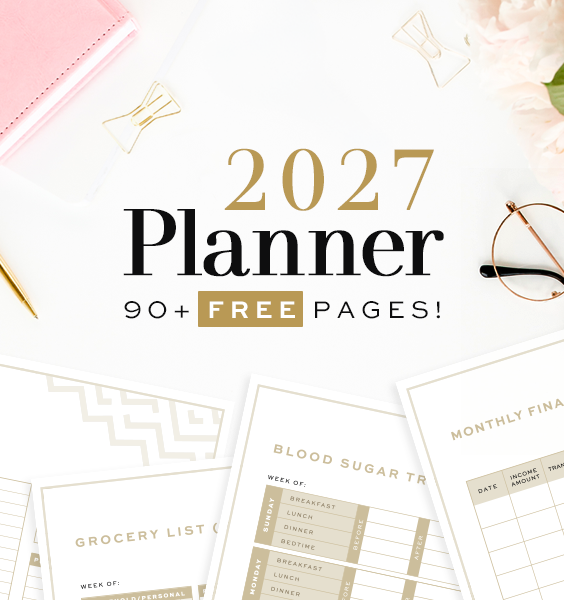 Preview of the free 2027 printable planner showing printed pages for a grocery list, blood sugar log, and monthly finance tracker . The pages are styled on a white desk with gold scissors, wire paper clips, reading glasses, and pink flowers